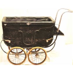 Antique baby buggy with top.