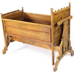 Antique oak mechanical baby cradle