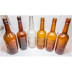Six Tooled Top Whiskey Bottles