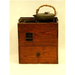 Late 19th C Japanese Keyaki (Asian Elm) Hibachi having a hand forged wrought iron handle and a singl