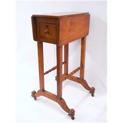 Drop leaf sewing stand in Regency style probably continental, turned stretchers, single pass through