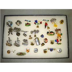 Thirty three travel pins mostly from Germany, some sterling, enameled, plastic, and one small 9kt & 