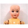 Image 1 : Bisque head doll with a ball jointed composition body. There is a "C" stamped in the back of the hea