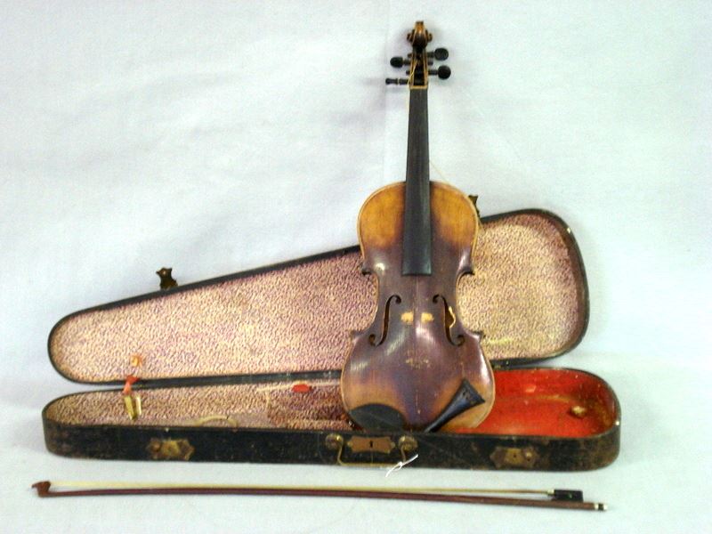 Violin with bow and case. Violin has a paper label