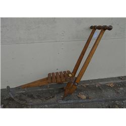 Unusual child's collapsible sled with 1 long runner and handles to permit an adult to push it throug