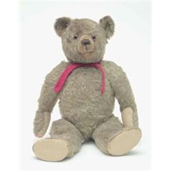 An English mohair teddy bear, pre-war, blonde plush with glass eyes and jointed limbs, 1ft 8.5ins...