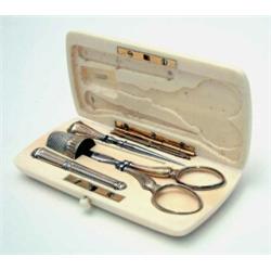 A French ivory cased etui, late 19th century, fitted with steel and gilt silver mounted sewing ut...