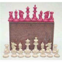 An English bone chess set, late 19th century, with turned sectional pieces in red stained and nat...