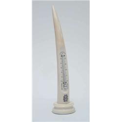 An ivory elephant tusk thermometer, early 20th century, one side mounted with a thermometer and a...