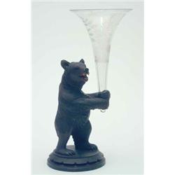 A late 19th century Swiss carved wood bear, standing upright on hind legs, holding engraved glass...
