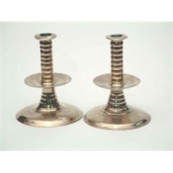A pair of Charles II brass trumpet base candlesticks, c.1660, each with ribbed stem, (one with so...