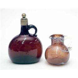 A late Victorian amber glass bottle, with applied handle and brass stopper, 7.5ins and a Nailsea...