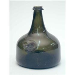 A George I sealed wine bottle, onion shape with high basal kick, seal named Welman and dated 1723...