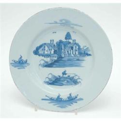 An 18th century London Delft plate, painted Chinese riverscapes in blue (cracked) 9ins...