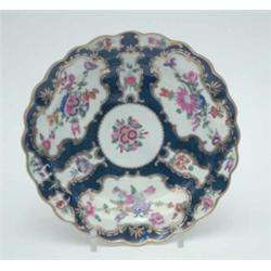 An 18th century Worcester saucer dish, painted with bright flowers within gilt reserves against a...