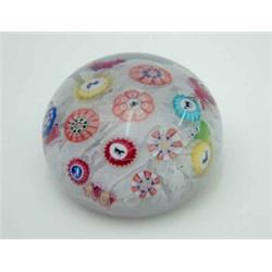 A mid 19th century Baccarat glass paperweight, inset with four 4-legged animal silhouettes, withi...