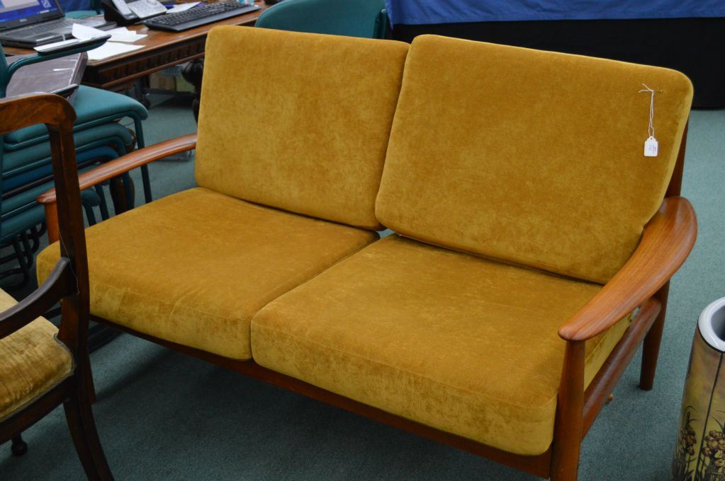 Midcentury modern teak framed loveseat with original finish and