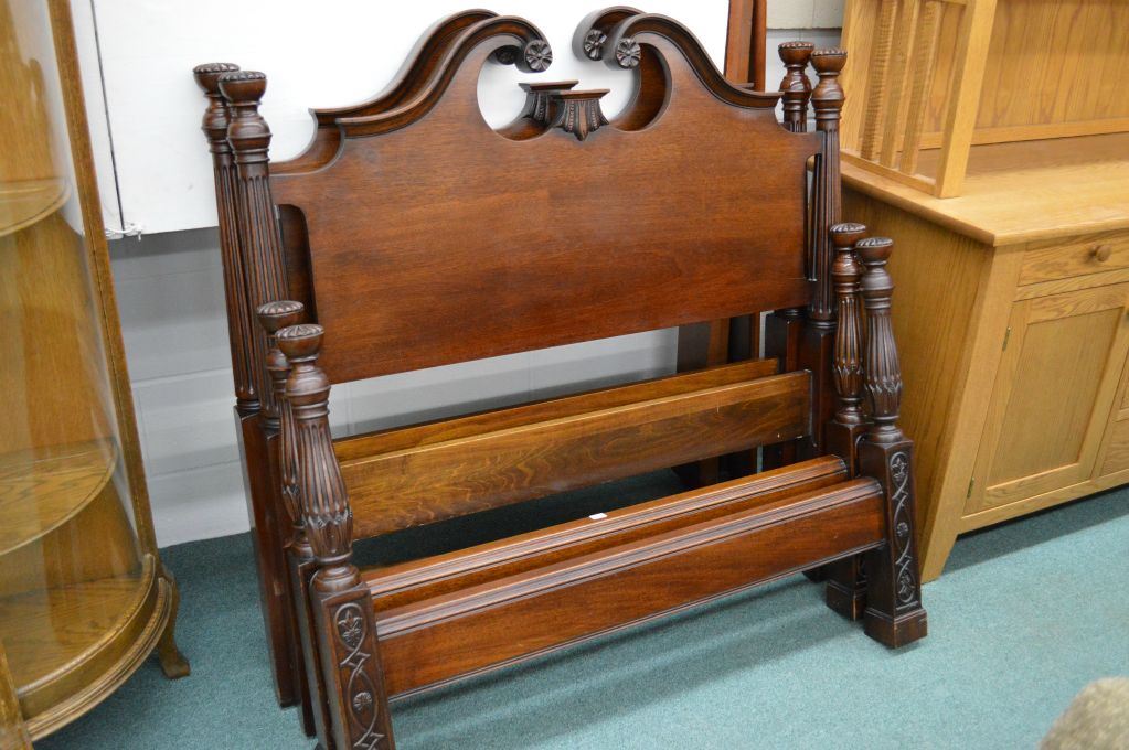 A pair of matching vintage wooden single beds including headboard