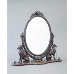 A finely carved 19th century mahogany oval toilet mirror surmounted by a fox head trophy on ivy e...