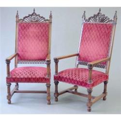 A pair of 19th century French walnut Gothic design throne chairs with ornate carved pediments ove...