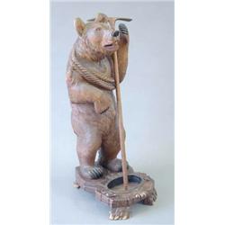 An early 20th century Swiss bear stick stand modelled as a mountaineer with ropes and ice axe on...