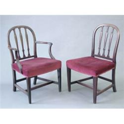 A set of 9 George III mahogany dining chairs (including one with arms) with hooped triple splat b...