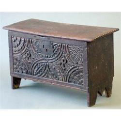 An early 17th century oak 6-plank coffer with leaf carved front initialled 'RR' and double stampe...
