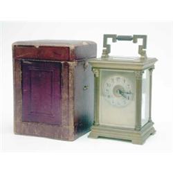 An unusually large brass carriage clock, with circular silvered dial, the French movement with...