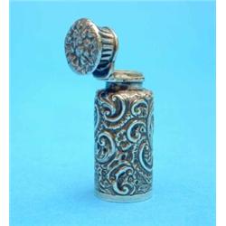 A late Victorian silver scent flask, with scroll decoration, 2 ins....