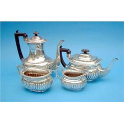 A George V 4- piece silver tea and coffee set, of demi-fluted rectangular form, 1911, Gross 53oz....
