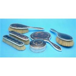 A 5-piece silver and tortoiseshell pique dressing table set and a similar jewellery casket....
