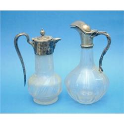A Victorian cut glass claret jug with plated mount and a later claret jug....