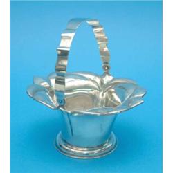 A French white metal sugar basket with swing handle....