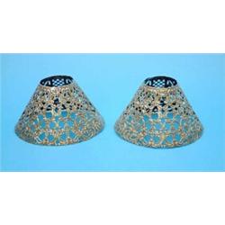A pair of American Gorham embossed white metal lamp shades....