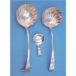 Two George III silver sauce ladles with scallop bowls and a caddy spoon....