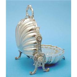 A Victorian plated biscuit box of scallop form with scrollwork frame....
