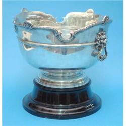 A George V silver punch bowl, with serpentine rim and lions mark loop handles, Birmingham, 1928,...