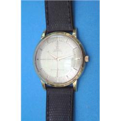A gentlemans 18ct gold Omega Automatic wrist watch. with baton numerals and champagne dial....