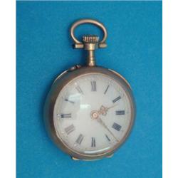 A small Swiss gold keyless fob watch. with ruby and diamond set case and enamel dial....