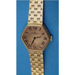 A ladys 18ct gold Baume and Mercier wrist watch with hexagonal dial and textured bracelet....