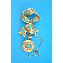 A Victorian gold tied ribbon brooch, set foliate engraved turquoise coloured pastes supporting a...