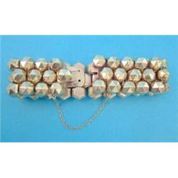 A French gold flexible bracelet, of faceted hexagonal linking, 47.2grms...