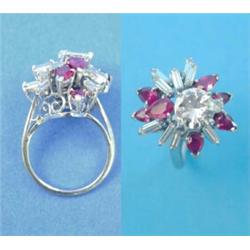 An 18ct white gold diamond and ruby dress ring, set with a brilliant cut diamond (approximately 1...