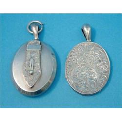 A Victorian silver oval pendant locket, with foliate engraved decoration, together with another s...