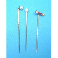 A gold stickpin, set 2 diamonds and four calibre cut rubies, together with 2 gold and pearl stick...