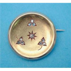 A Victorian gold circular brooch, decorated with diamond set clover leaf motifs...