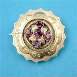 A Victorian gold circular brooch, with wirework decoration, set 5 amethysts, locket back...