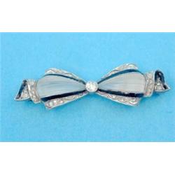 A white gold, rock crystal, diamond and black enamel bow brooch...