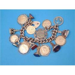 A 9ct gold curblink bracelet, with padlock clasp and 17 various charms including sovereigns, half...