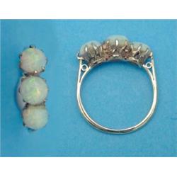 A three stone opal ring, claw set in 18ct gold...